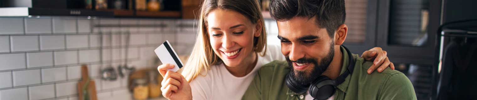 Couple using their credit card shopping online.