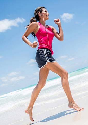 Person jogging at the beach.