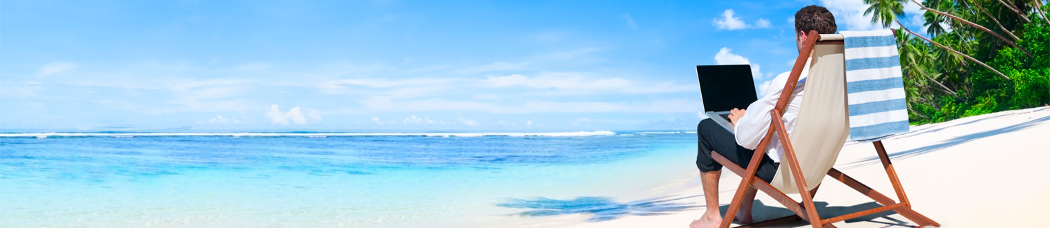 Person working on laptop at the beach